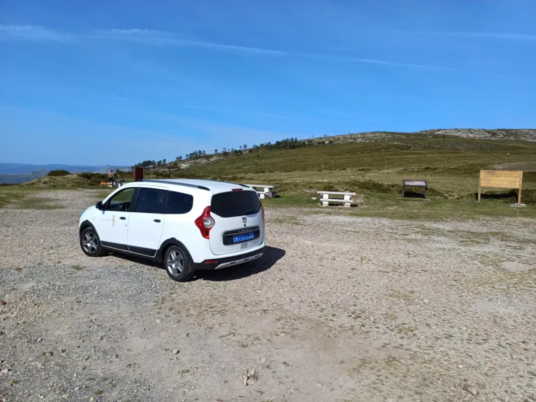 Taxi furgoneta en un camino de tierra junto a una zona de merendero